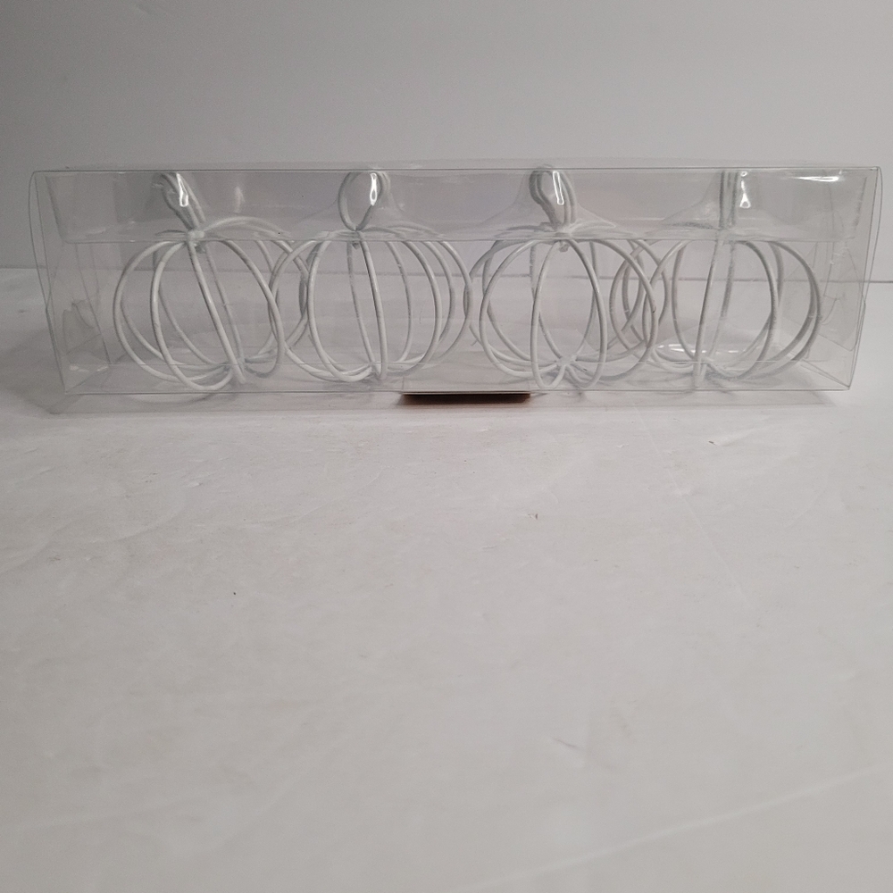 White pumpkin-shaped wire- frame decor. 294